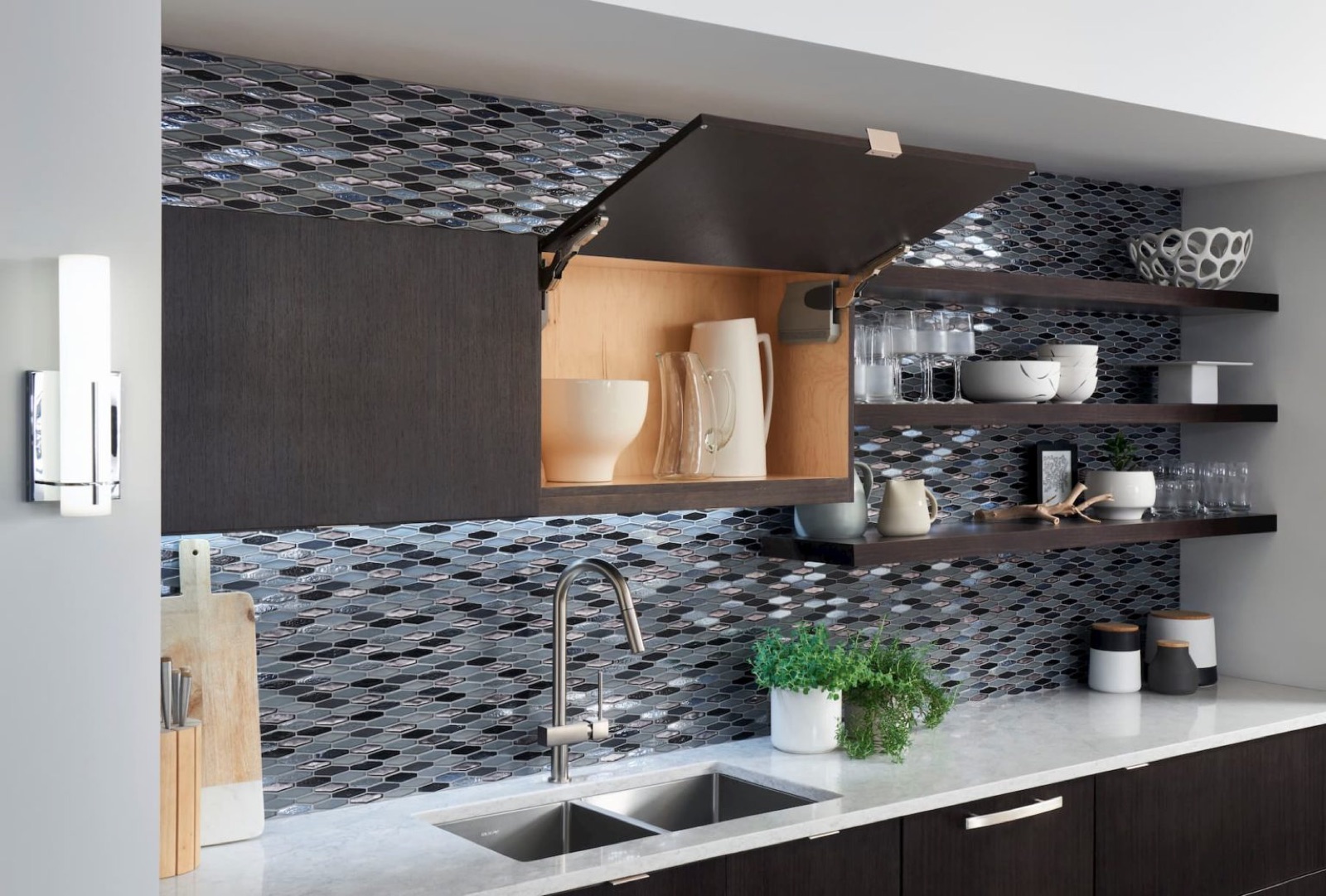 Dark kitchen cabinetry with stone counters