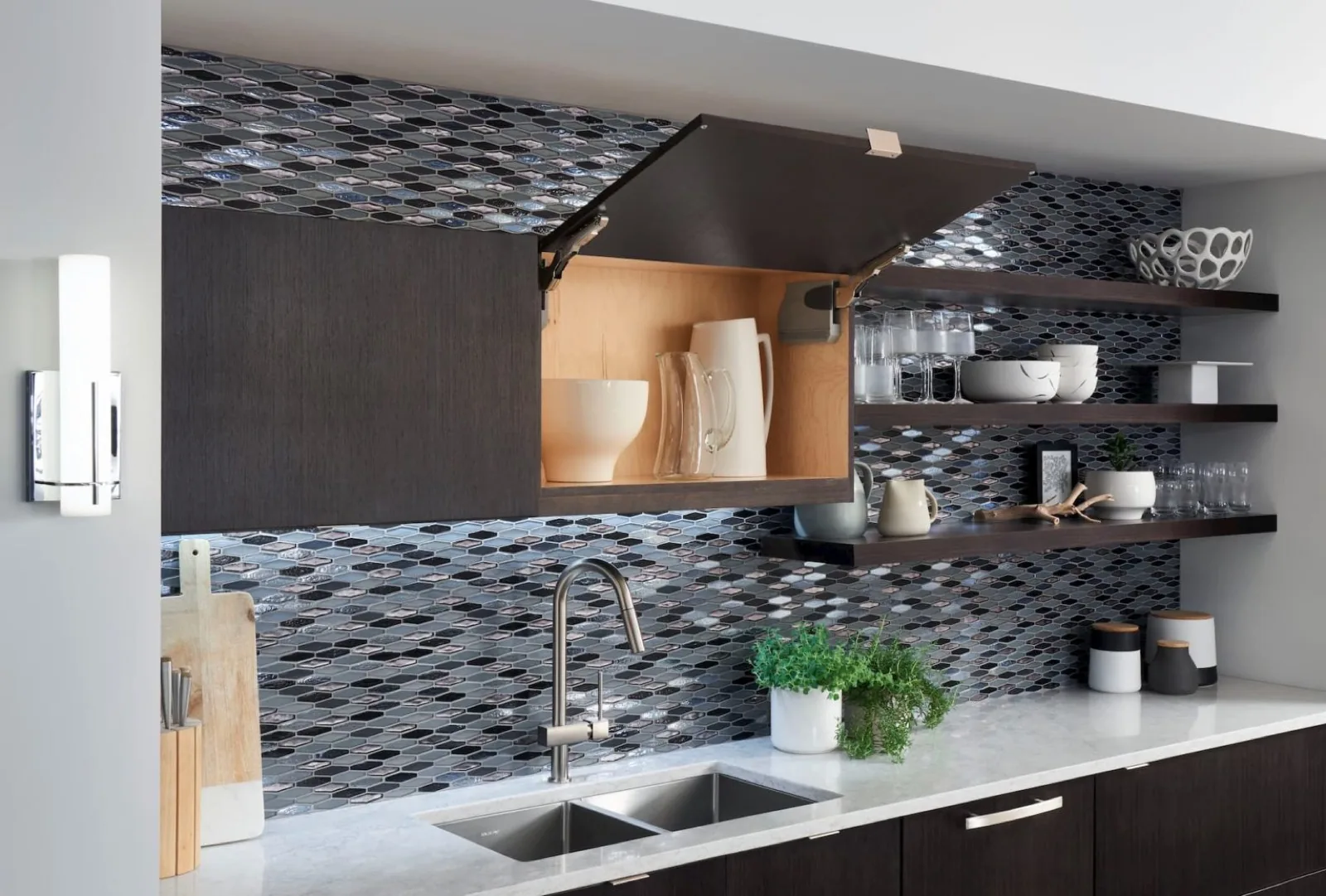 Dark kitchen cabinetry with stone counters